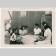 Six girls playing jacks on a table (ddr-densho-475-403)