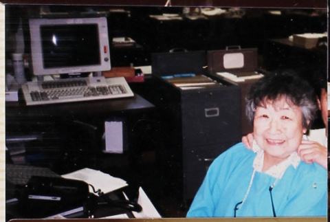 Woman in blue seated in office (ddr-densho-426-1281)