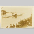 Men at a dock waving to sailors on a passing U-boat (ddr-njpa-13-998)