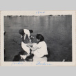 Two women in shallow river edge (ddr-densho-464-68)