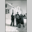 Sakura family standing in snow outside house, with cat (ddr-densho-523-237)