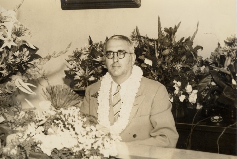 Gregg M. Sinclair seated with flowers (ddr-njpa-2-1160)