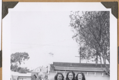 Three women by a car (ddr-densho-542-76)