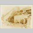 Men examining damage from a bombing (ddr-njpa-13-309)