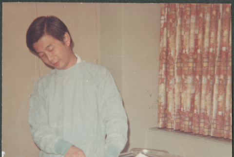 Man with baby in hospital (ddr-densho-523-481)