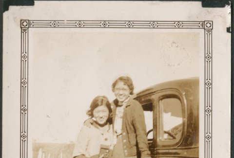 Two women by car (ddr-densho-316-183)