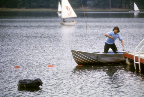 Stuart Wong trying to retrieve a bag in the water (ddr-densho-336-878)