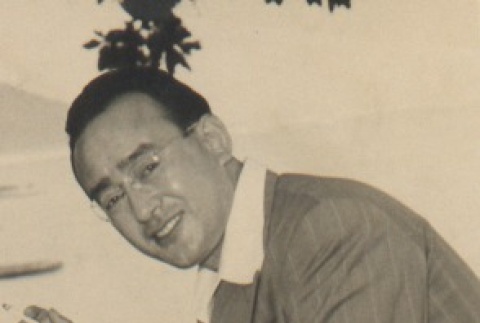 Man seated holding a cigarette (ddr-njpa-4-271)