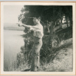 Henri Takahashi on river bank, pointing (ddr-densho-410-564)