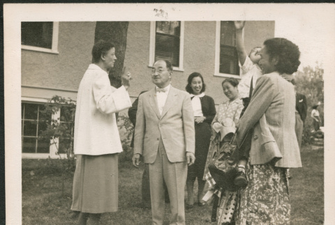 Group standing on lawn talking (ddr-densho-293-148)