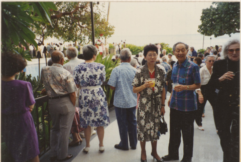 Couple standing with crowd behind them (ddr-densho-466-485)