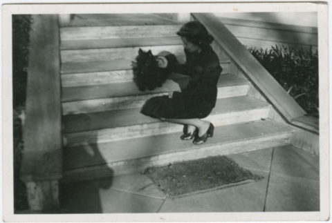 A woman on stairs with a dog (ddr-densho-338-302)