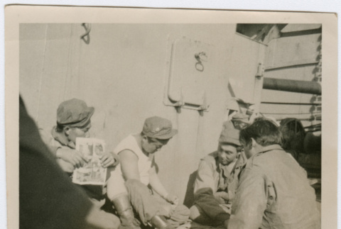 Soldiers socializing on deck of ship (ddr-densho-368-33)