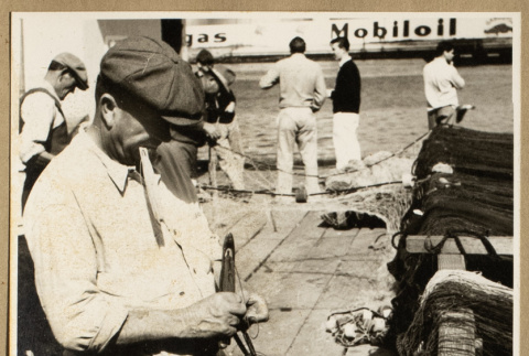 Man working on a fishing net (ddr-densho-542-783)