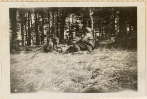 Three men relaxing on grassy hillside (ddr-densho-466-257)