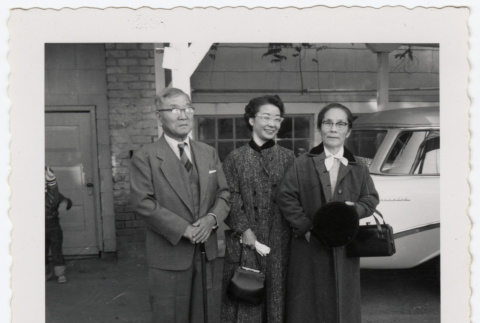 Two women and a man outside a building (ddr-densho-433-565)