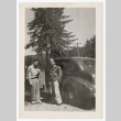 Tokeo Tagami and another man stand next to a car (ddr-densho-404-424)