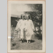 Two women wearing graduation caps and gowns (ddr-manz-10-65)