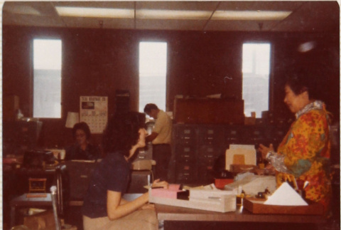 Four people working in office (ddr-densho-426-1250)