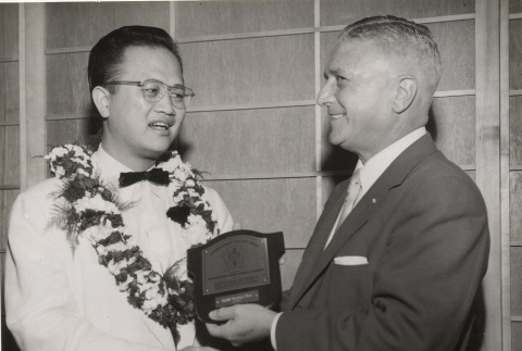A Chinese man receiving a plaque from another man (ddr-njpa-2-418)