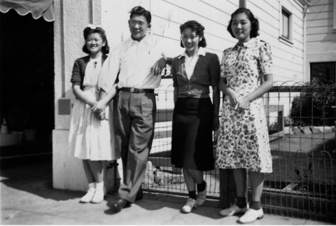 Kono family standing outside family business (ddr-ajah-6-342)