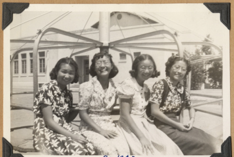Four girls on a merry-go-round (ddr-densho-542-194)