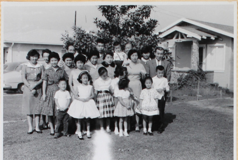 Large group of men, women and children in yard outside house (ddr-densho-522-58)