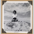 Ruth (Saitow) Kikawa seated on a sand dune (ddr-densho-542-345)