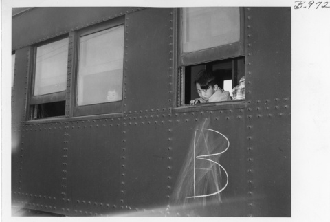 A boy looking out of a train window (ddr-fom-1-915)