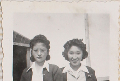 Two women standing outside barracks (ddr-densho-464-19)
