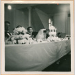 Henri Takahashi and Tomoye (Nozawa) Takahashi seated at head table with wedding cake (ddr-densho-410-492)