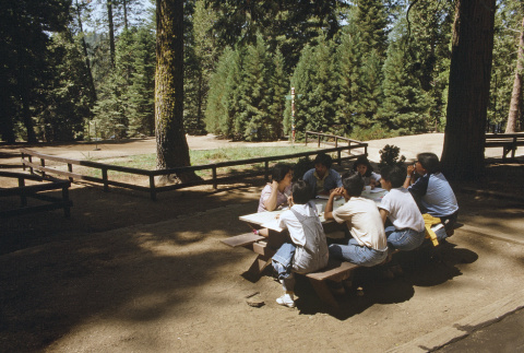 Campers sitting at a picnic table (ddr-densho-336-1713)