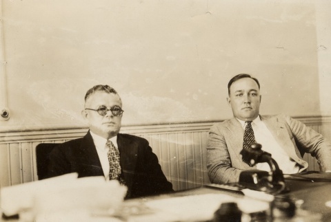 Two men seated behind a desk (ddr-njpa-2-342)