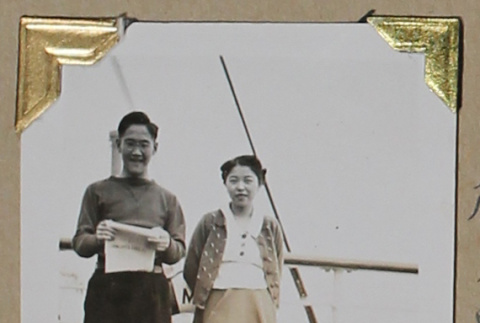 Man and woman lean against the rail of a ship (ddr-densho-404-234)