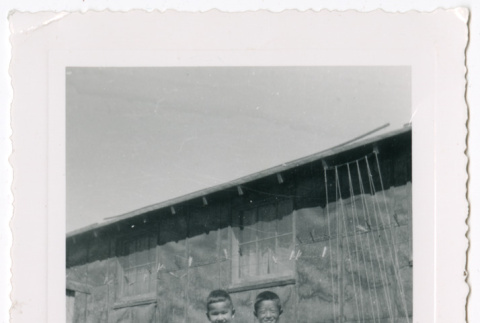 Photo of two children outside a barrack (ddr-densho-483-43)
