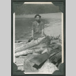 Man sitting near wood debris (ddr-densho-540-76)