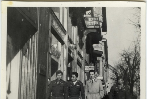 Soldiers and civilian on commercial street (ddr-densho-201-159)