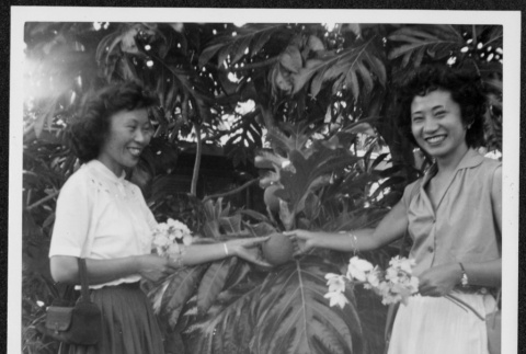 Two women holding breadfruit (ddr-densho-363-144)