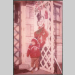 Boy standing by snowman decoration (ddr-densho-523-556)