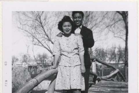 Couple on a bridge in Manzanar's garden (ddr-manz-10-115)
