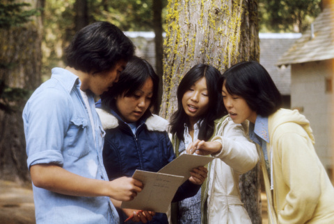 Campers looking at notepads (ddr-densho-336-749)