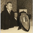 Go expert posing with plaque (ddr-njpa-4-601)