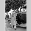 Tomoye (Nozawa) Takahashi standing by car (ddr-densho-426-2011)
