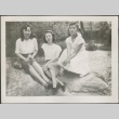 Three women sitting on a rock (ddr-densho-298-174)