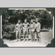 Four men in fatigues standing by trees (ddr-ajah-2-267)