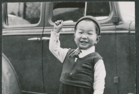 Boy standing by car (ddr-densho-523-77)