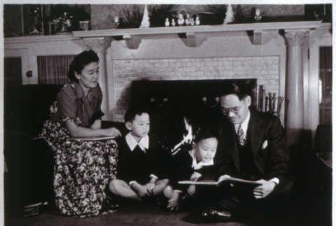 Family reading in front of fireplace (ddr-densho-1007-650)