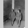 Nisei soldier escorting a Japanese officer to a war crimes trial tribunal (ddr-densho-107-37)