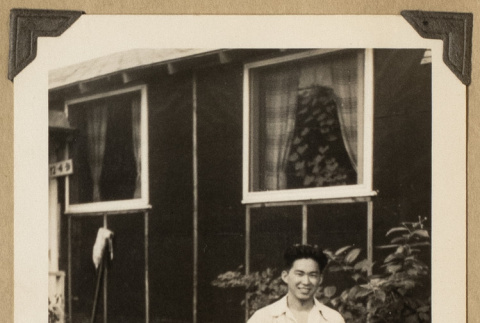 Gary Kikawa outside a barrack (ddr-densho-542-523)