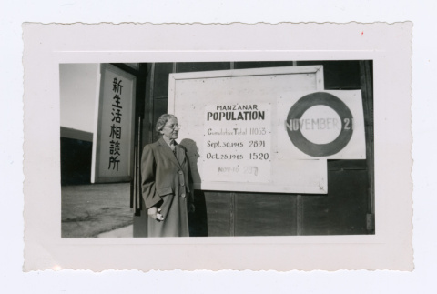 Manzanar population sign with white woman (ddr-densho-402-34)